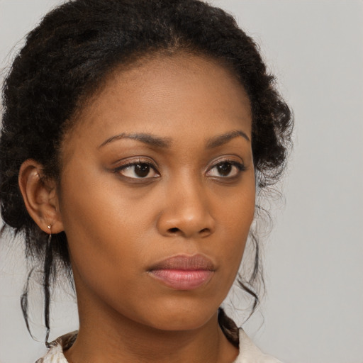 Neutral black young-adult female with medium  brown hair and brown eyes