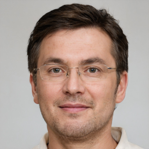 Joyful white adult male with short  brown hair and grey eyes