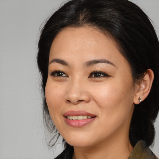Joyful asian young-adult female with long  brown hair and brown eyes