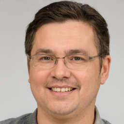 Joyful white adult male with short  brown hair and grey eyes