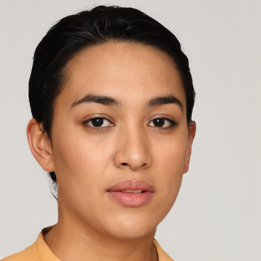 Joyful latino young-adult female with short  brown hair and brown eyes