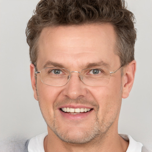 Joyful white adult male with short  brown hair and grey eyes