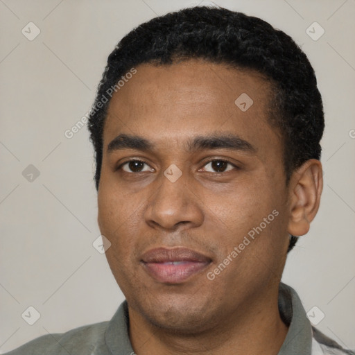 Joyful black young-adult male with short  black hair and brown eyes