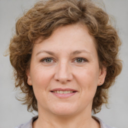 Joyful white adult female with medium  brown hair and grey eyes