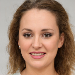 Joyful white young-adult female with medium  brown hair and green eyes