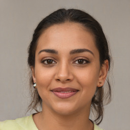 Joyful latino young-adult female with medium  brown hair and brown eyes