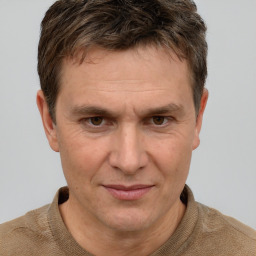 Joyful white adult male with short  brown hair and grey eyes