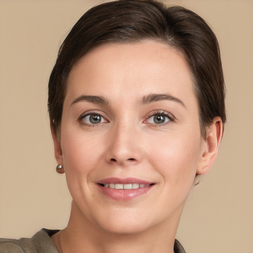 Joyful white young-adult female with short  brown hair and brown eyes