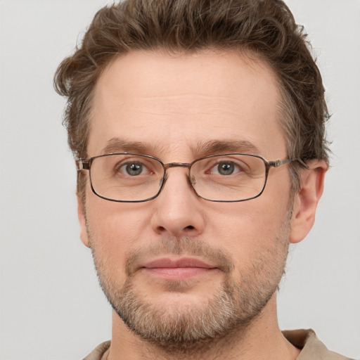 Joyful white adult male with short  brown hair and grey eyes