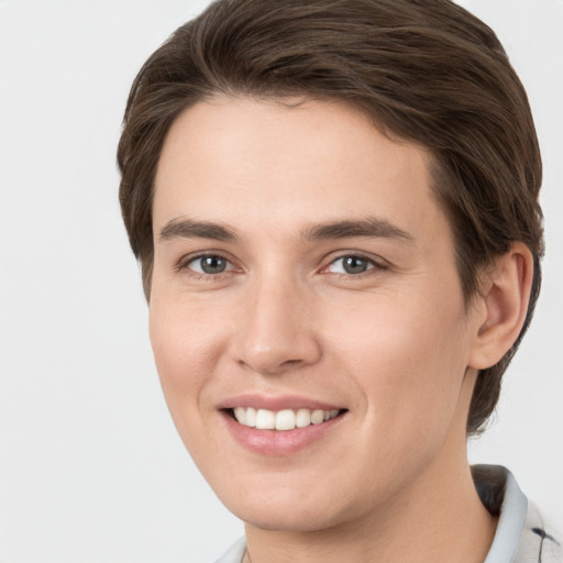 Joyful white young-adult female with short  brown hair and grey eyes