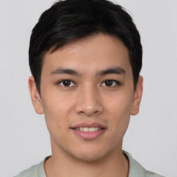 Joyful asian young-adult male with short  black hair and brown eyes