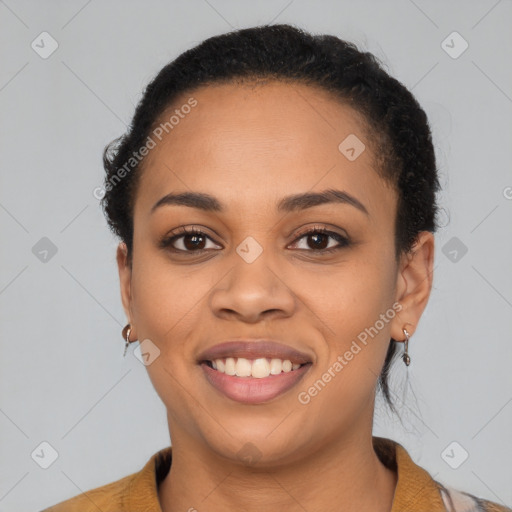 Joyful latino young-adult female with short  black hair and brown eyes