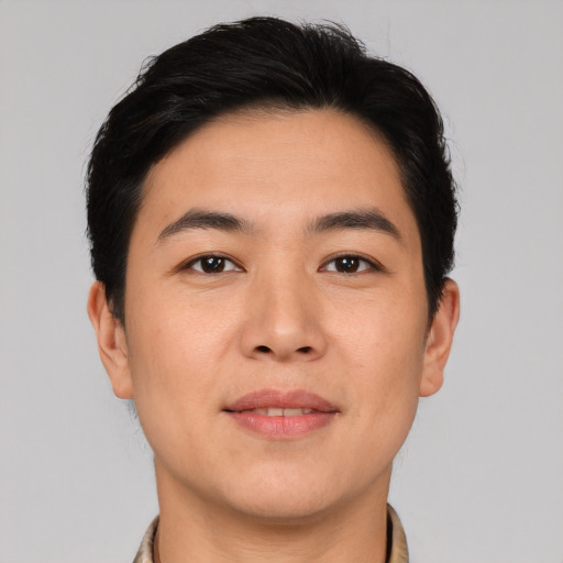 Joyful asian young-adult male with short  brown hair and brown eyes