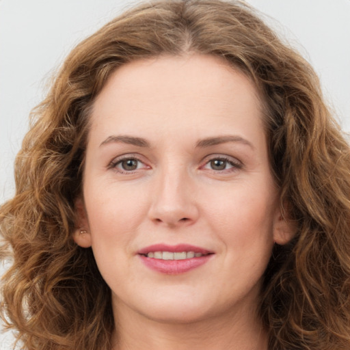 Joyful white young-adult female with long  brown hair and green eyes