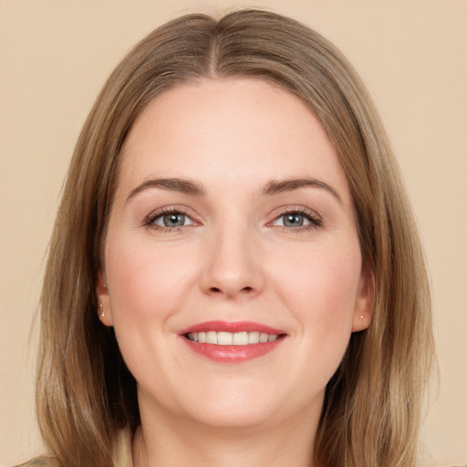 Joyful white young-adult female with long  brown hair and green eyes