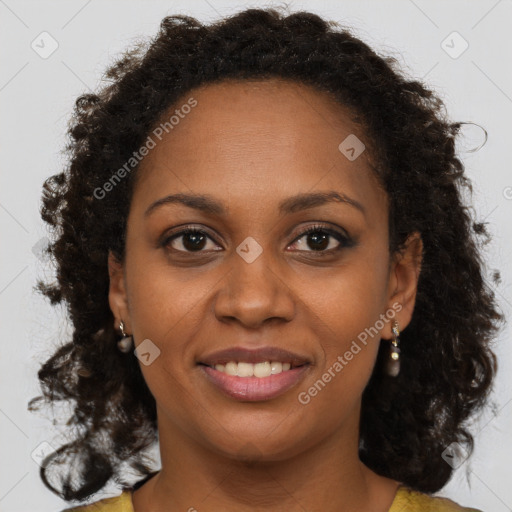 Joyful black young-adult female with long  brown hair and brown eyes