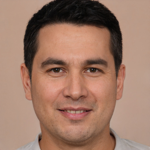 Joyful white adult male with short  brown hair and brown eyes