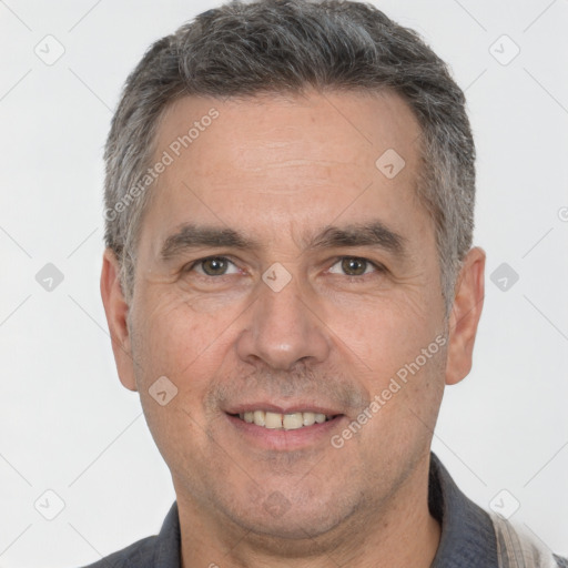 Joyful white adult male with short  brown hair and brown eyes