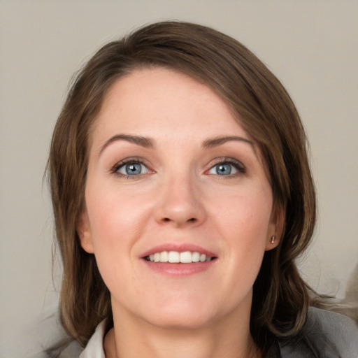 Joyful white young-adult female with medium  brown hair and blue eyes