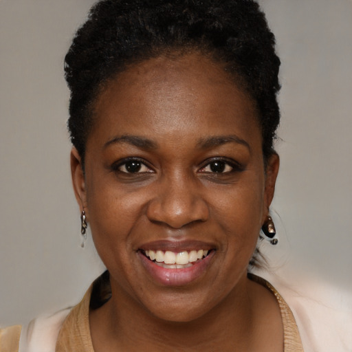 Joyful black young-adult female with short  brown hair and brown eyes