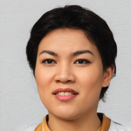 Joyful asian young-adult female with short  black hair and brown eyes