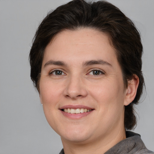 Joyful white young-adult female with medium  brown hair and brown eyes