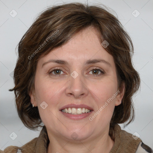 Joyful white adult female with medium  brown hair and blue eyes