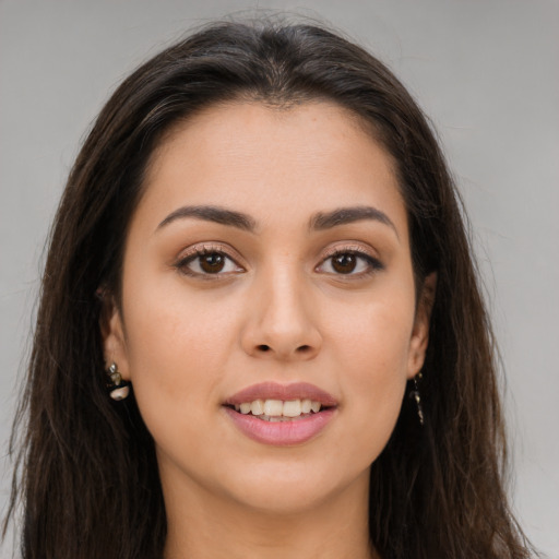 Joyful white young-adult female with long  brown hair and brown eyes