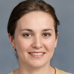 Joyful white young-adult female with medium  brown hair and grey eyes