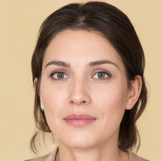 Joyful white young-adult female with medium  brown hair and brown eyes