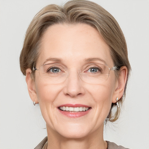 Joyful white adult female with medium  brown hair and grey eyes