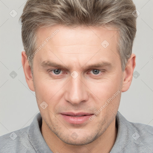 Joyful white adult male with short  brown hair and grey eyes