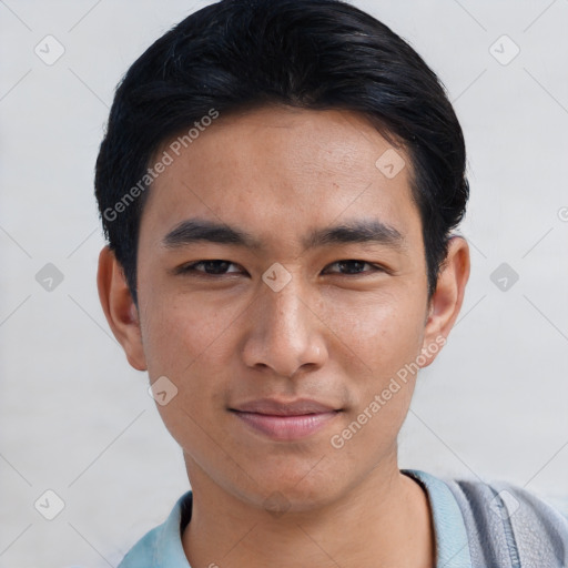 Joyful asian young-adult male with short  black hair and brown eyes