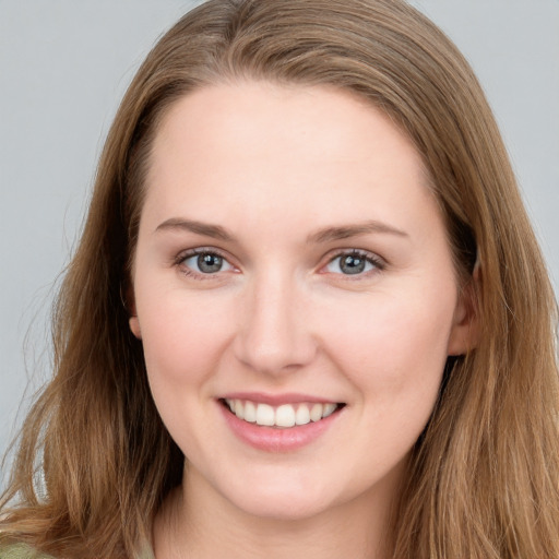 Joyful white young-adult female with long  brown hair and grey eyes