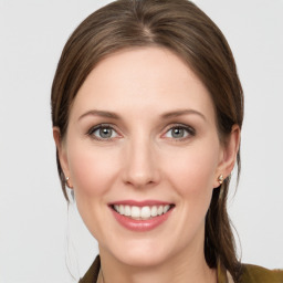 Joyful white young-adult female with medium  brown hair and grey eyes