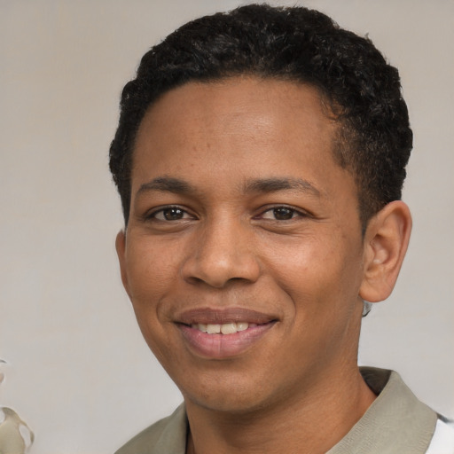 Joyful black young-adult male with short  brown hair and brown eyes