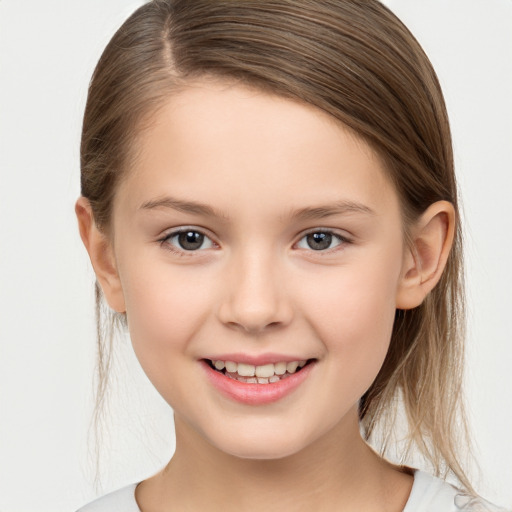 Joyful white child female with medium  brown hair and brown eyes