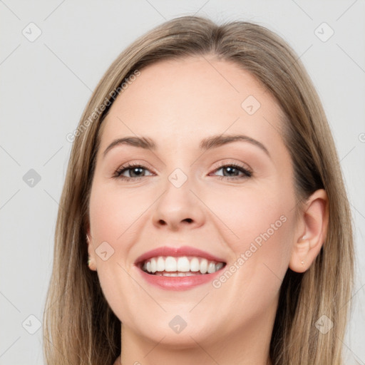 Joyful white young-adult female with long  brown hair and grey eyes