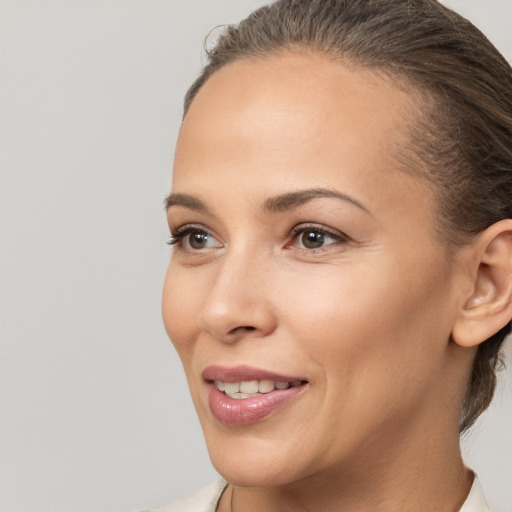 Joyful white young-adult female with medium  brown hair and brown eyes