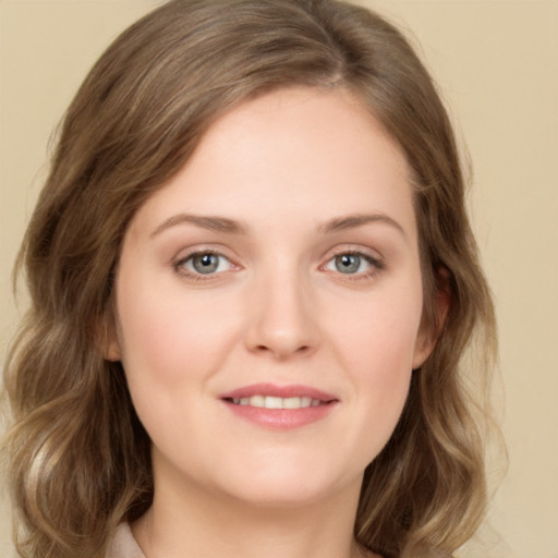 Joyful white young-adult female with medium  brown hair and green eyes