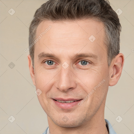 Joyful white adult male with short  brown hair and brown eyes