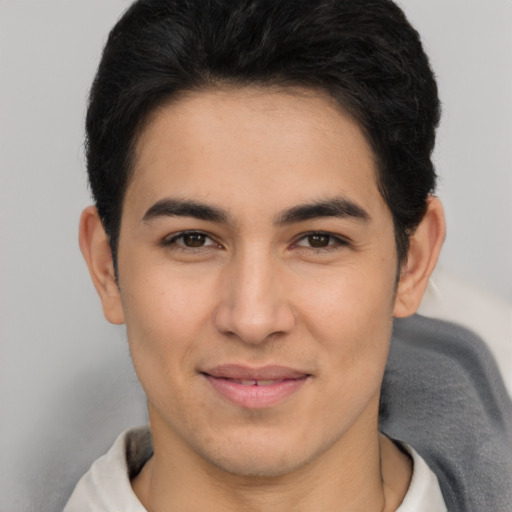 Joyful latino young-adult male with short  brown hair and brown eyes