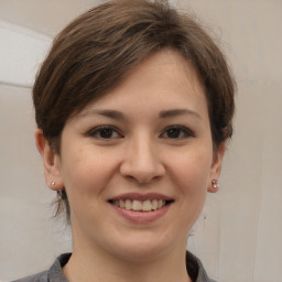 Joyful white young-adult female with medium  brown hair and brown eyes