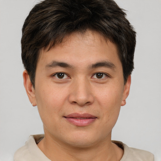 Joyful white young-adult male with short  brown hair and brown eyes