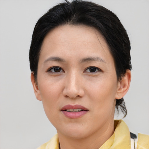 Joyful asian young-adult female with short  brown hair and brown eyes