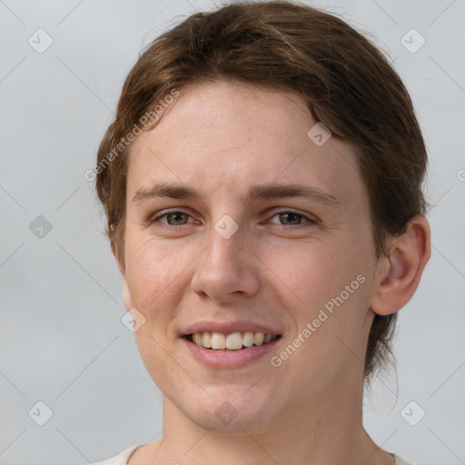 Joyful white young-adult female with short  brown hair and grey eyes