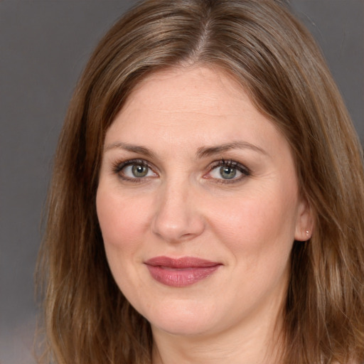 Joyful white adult female with long  brown hair and brown eyes