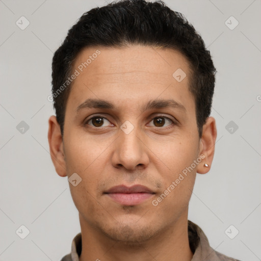 Joyful white young-adult male with short  black hair and brown eyes