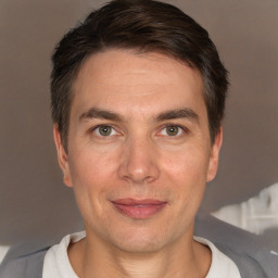 Joyful white adult male with short  brown hair and brown eyes