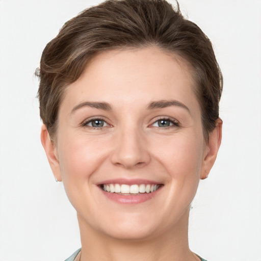 Joyful white young-adult female with short  brown hair and grey eyes